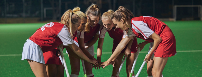 Girls play Hockey in a team during a Language course in Ardingly